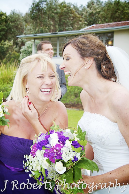 bride and bridesmaid laughing and drinking champagne - wedding photography sydney